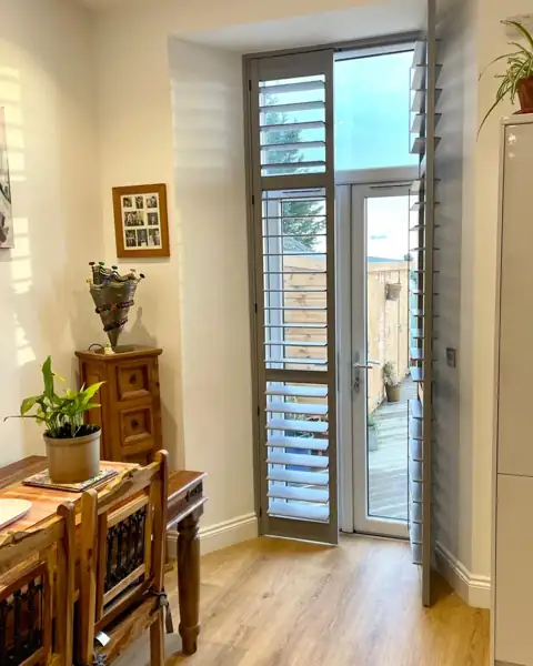 Full height hardwood shutters on French doors
